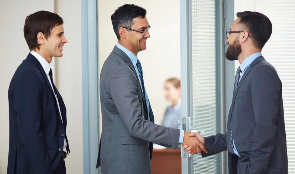 The mentor in professional attire opens a door