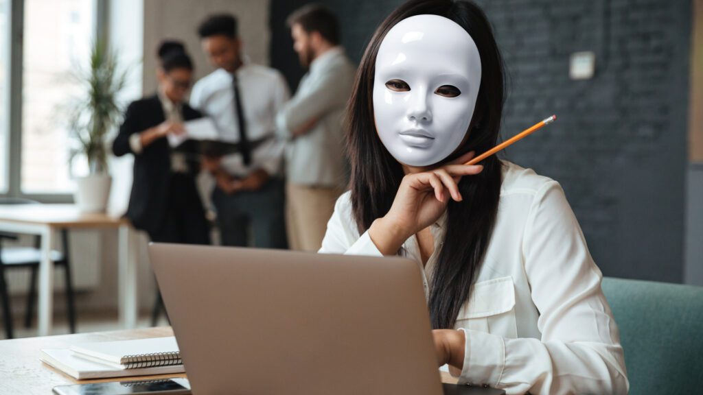 Do You Have Impostor Syndrome - An employee wearing a mask while working at the office - Outsourcing